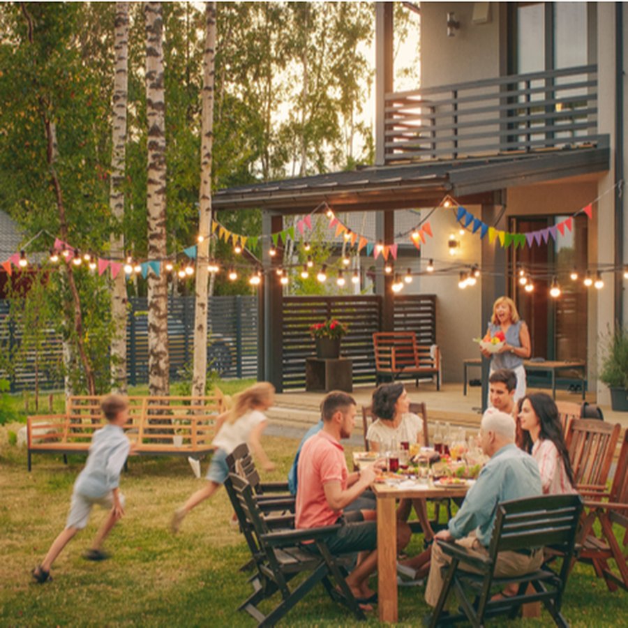 Family enjoying a backyard dinner at golden hour